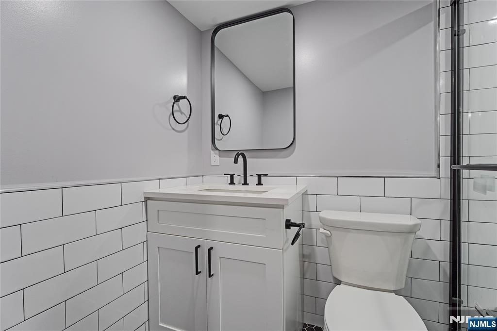 191 Franklin Street Secaucus, NJ 07094 - Photo 15 of 34 a bathroom with a toilet sink and mirror