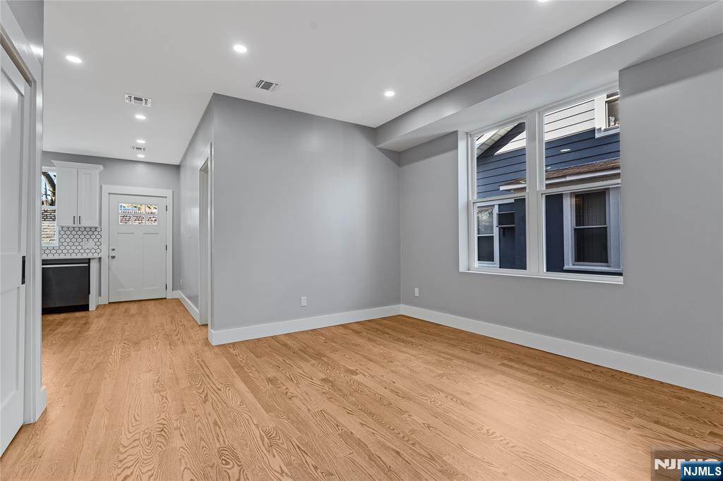 191 Franklin Street Secaucus, NJ 07094 - Photo 3 of 34 a view of empty room with wooden floor and kitchen