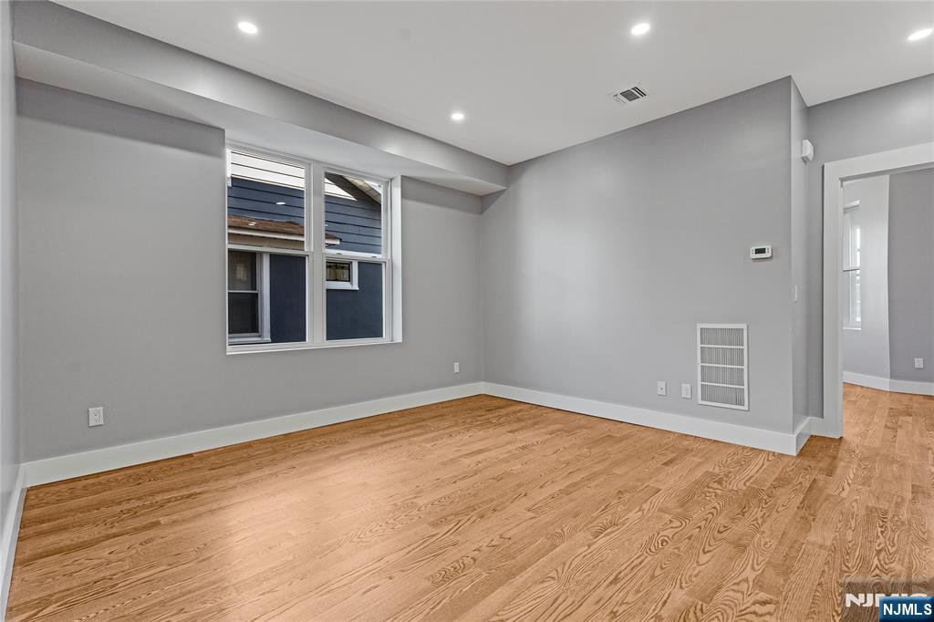 191 Franklin Street Secaucus, NJ 07094 - Photo 7 of 34 a view of empty room with wooden floor and fan