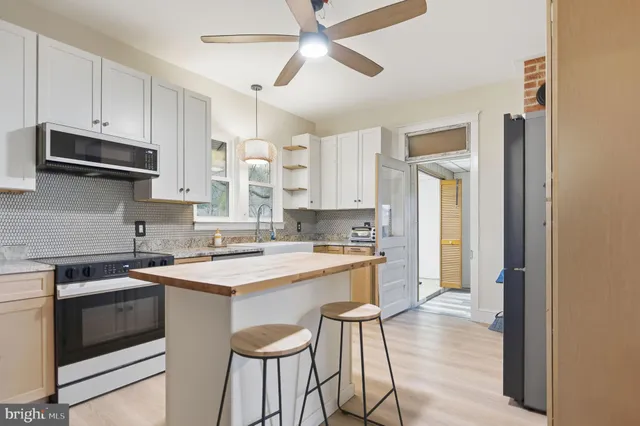 a kitchen with a stove a sink and a refrigerator