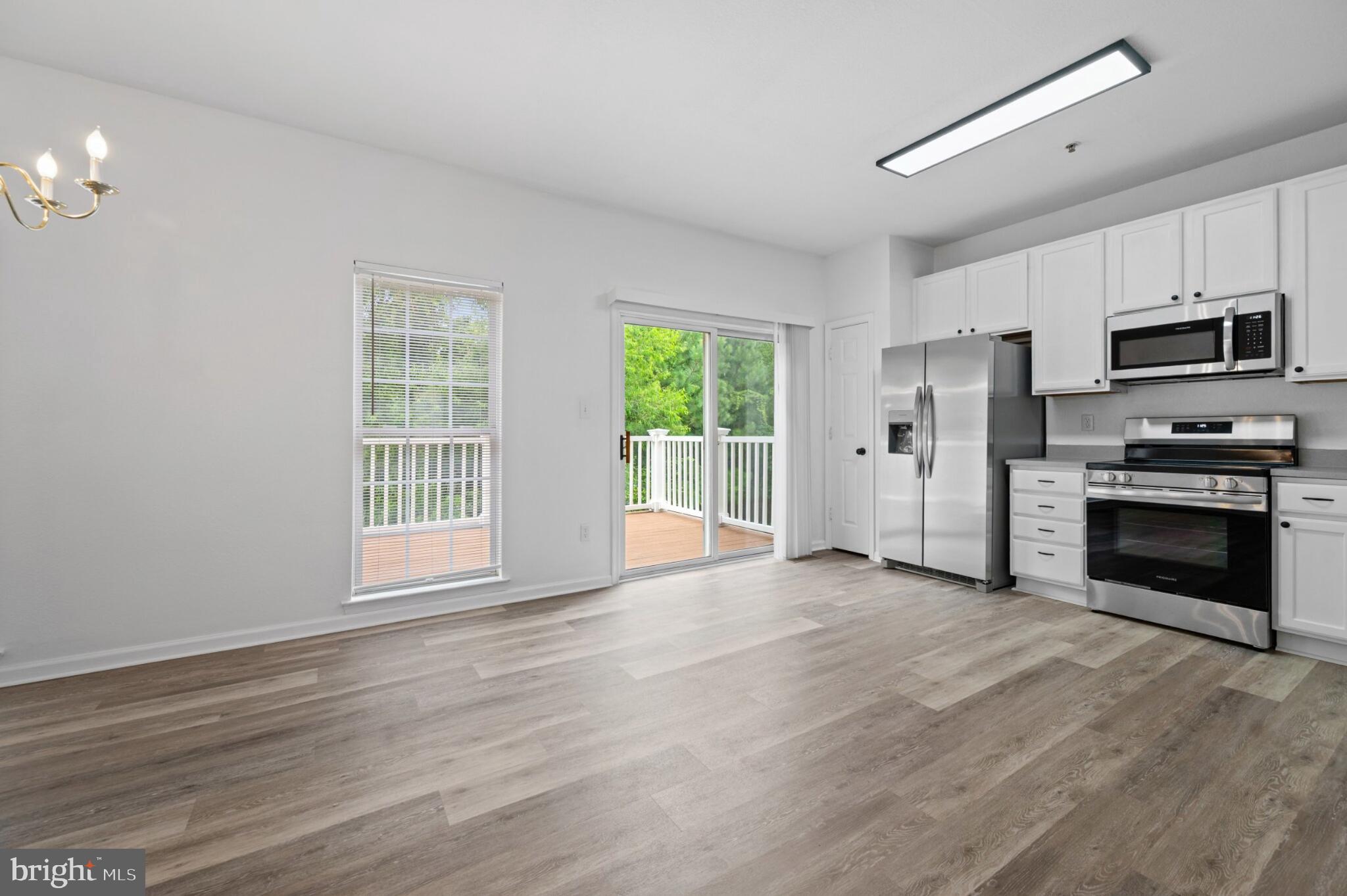 29 Pier Point Drive Millville, DE 19967 - Photo 5 of 36 a view of a kitchen with a stove cabinets and a wooden floor