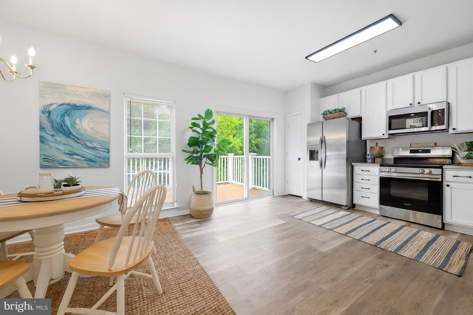 29 Pier Point Drive Millville, DE 19967 - Photo 6 of 36 a living room with stainless steel appliances furniture a fireplace and a open kitchen view