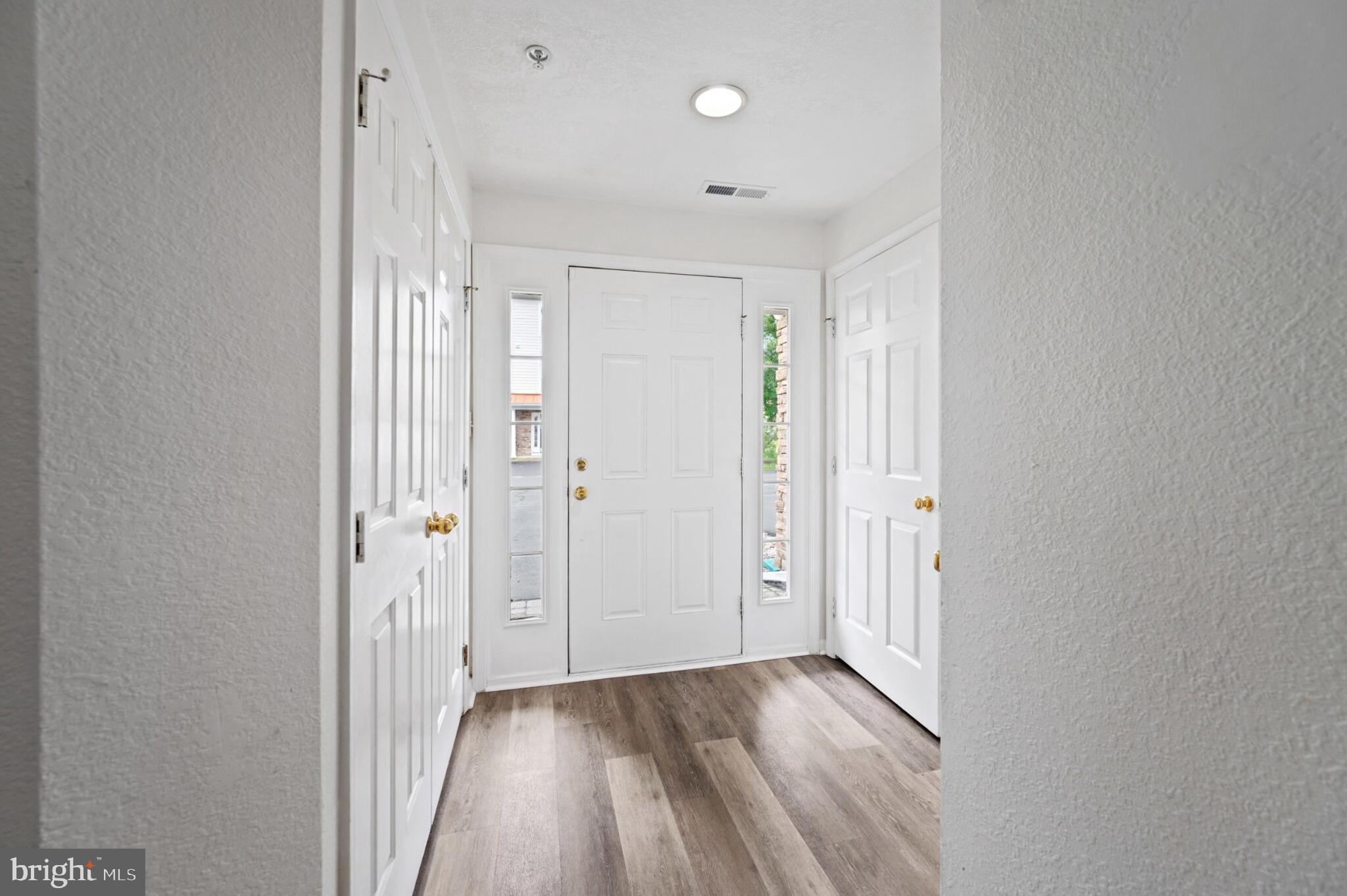 29 Pier Point Drive Millville, DE 19967 - Photo 7 of 36 a view of a hallway with wooden floor