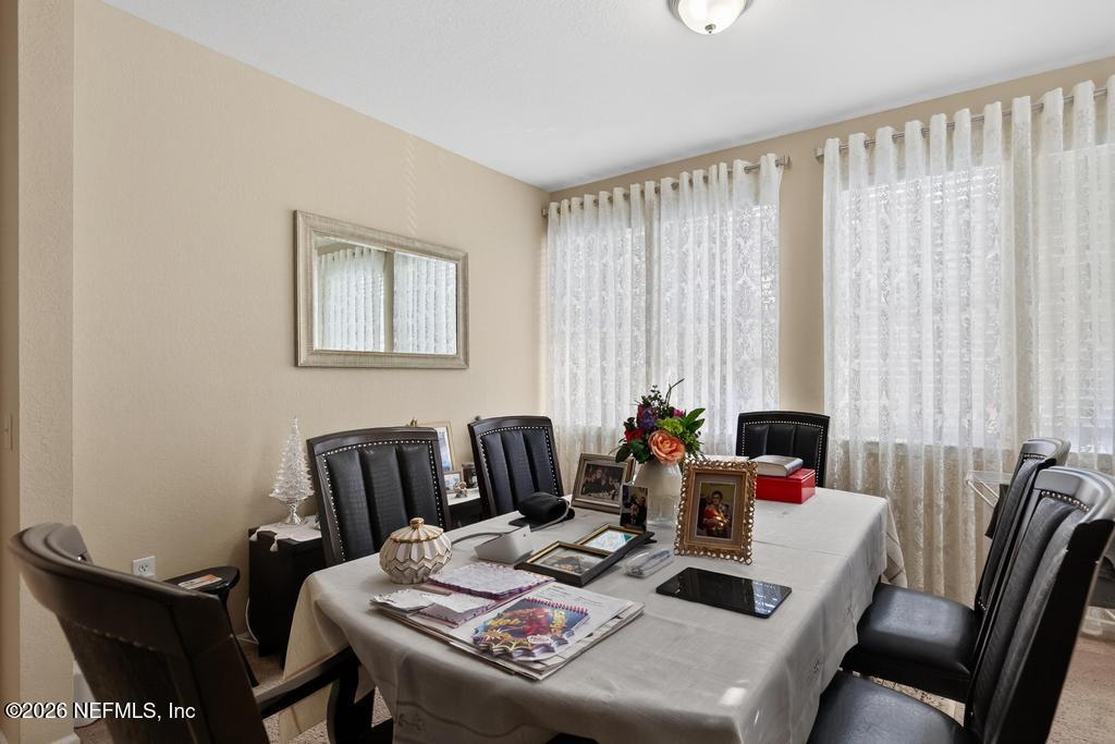 8550 Touchton Road, Unit 2221 Jacksonville, FL 32216 - Photo 11 of 53 a dining room with furniture and a window