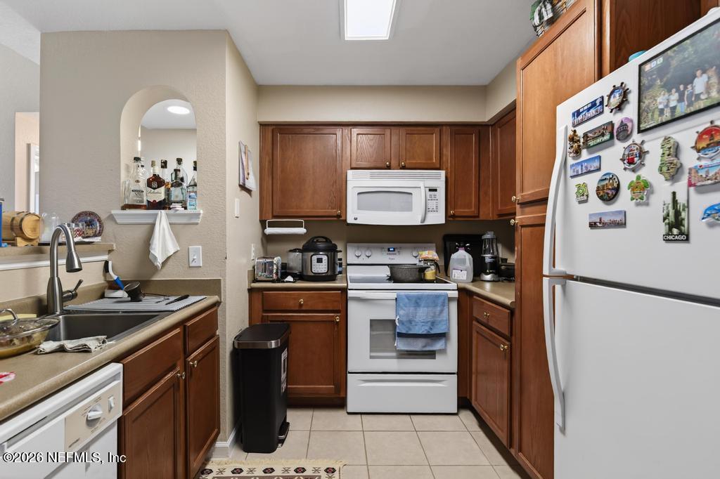 8550 Touchton Road, Unit 2221 Jacksonville, FL 32216 - Photo 15 of 53 a kitchen with stainless steel appliances a stove refrigerator sink and cabinets