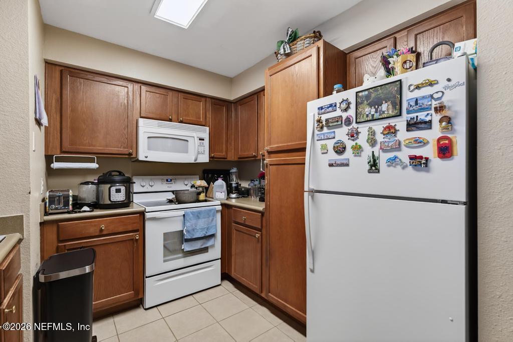 8550 Touchton Road, Unit 2221 Jacksonville, FL 32216 - Photo 17 of 53 a kitchen with stainless steel appliances a refrigerator sink and cabinets