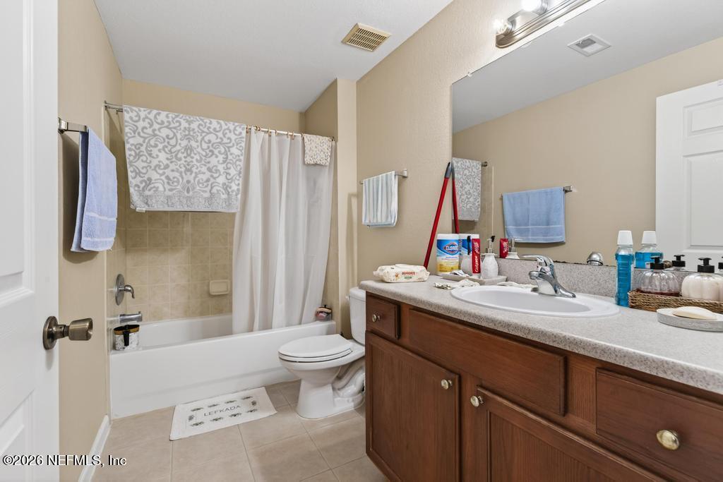 8550 Touchton Road, Unit 2221 Jacksonville, FL 32216 - Photo 20 of 53 a bathroom with a sink mirror vanity and toilet