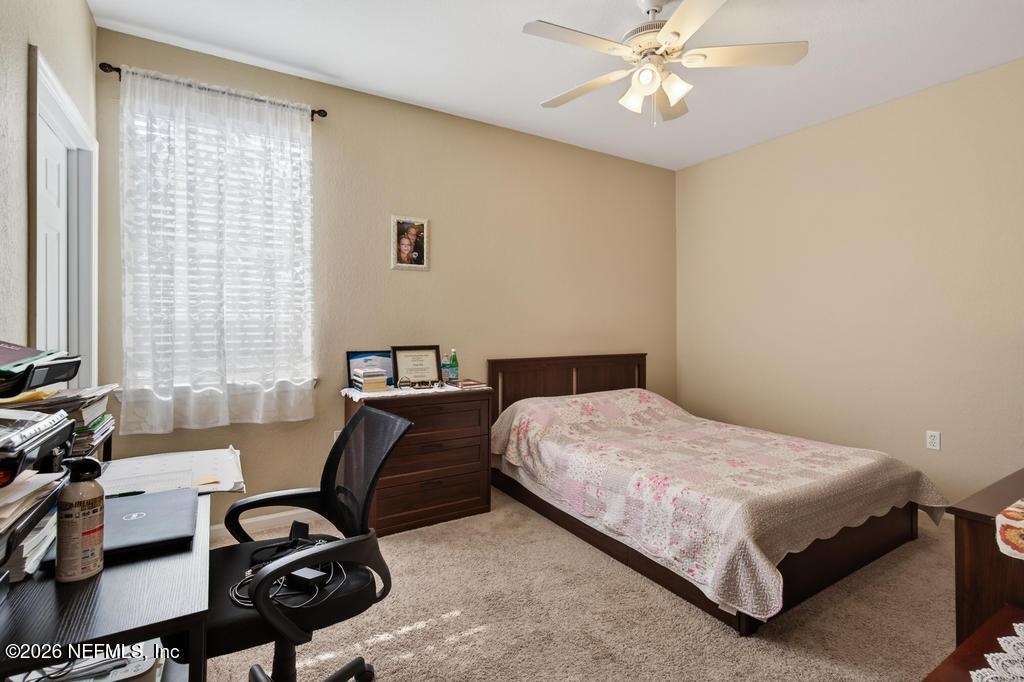 8550 Touchton Road, Unit 2221 Jacksonville, FL 32216 - Photo 22 of 53 a bedroom with a bed a desk and chair with window