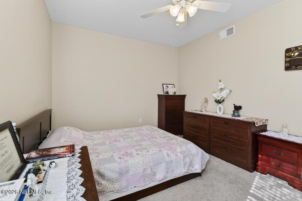 8550 Touchton Road, Unit 2221 Jacksonville, FL 32216 - Photo 23 of 53 a bedroom with a bed and a chandelier