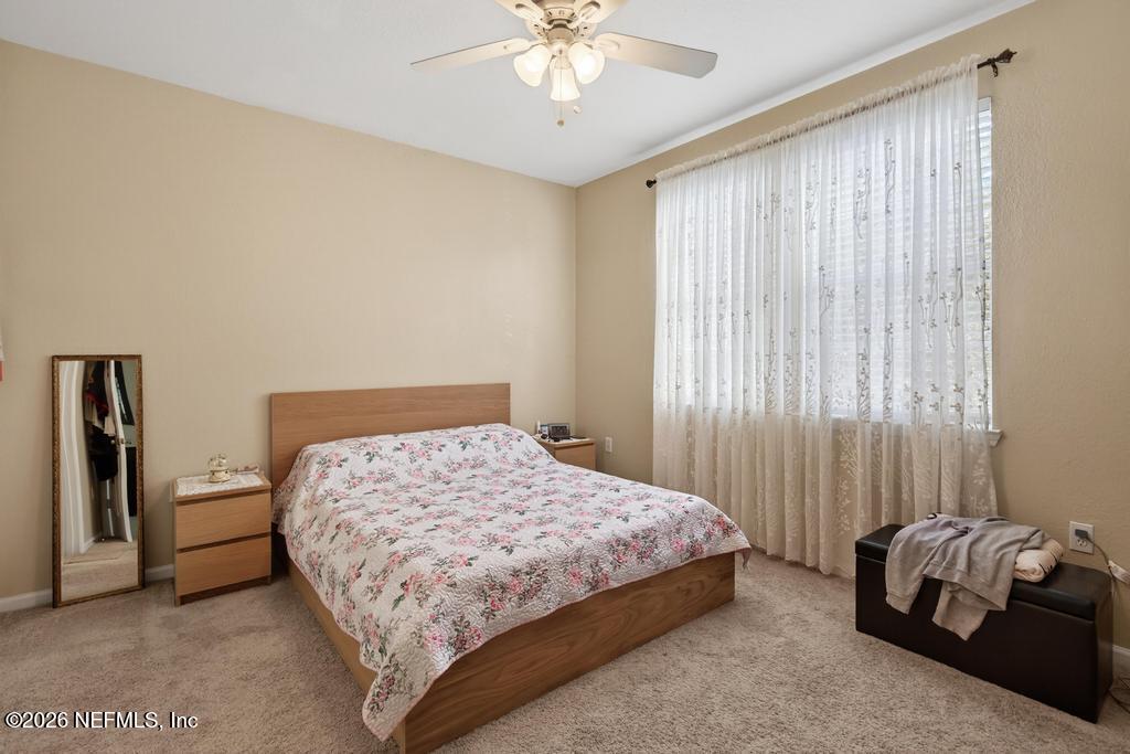 8550 Touchton Road, Unit 2221 Jacksonville, FL 32216 - Photo 24 of 53 a bedroom with a bed and a chandelier