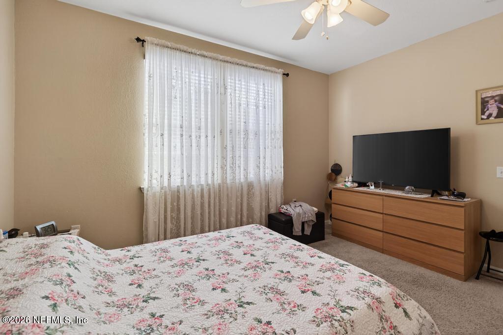 8550 Touchton Road, Unit 2221 Jacksonville, FL 32216 - Photo 25 of 53 a bedroom with a bed and a flat screen tv