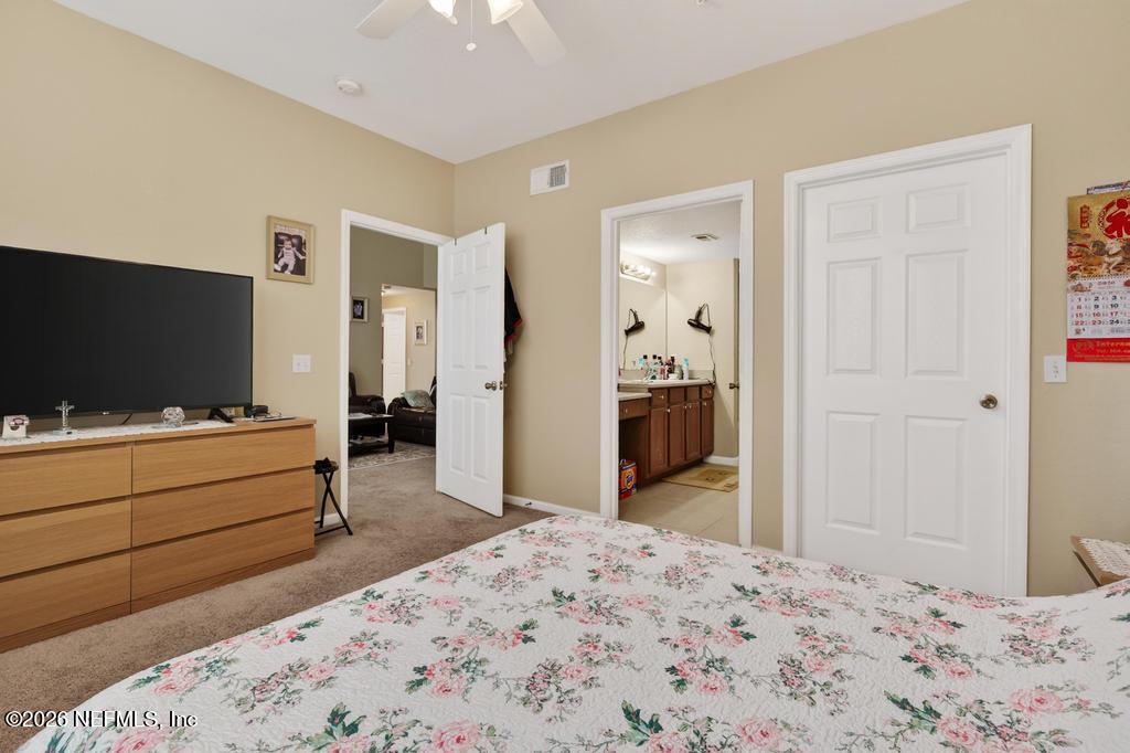 8550 Touchton Road, Unit 2221 Jacksonville, FL 32216 - Photo 26 of 53 a room with a bed and a flat tv screen in it