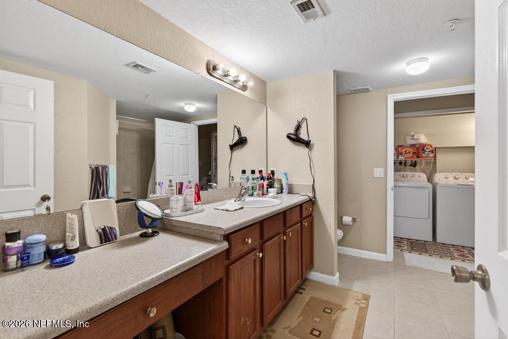 8550 Touchton Road, Unit 2221 Jacksonville, FL 32216 - Photo 28 of 53 a bathroom with a sink double vanity and a mirror
