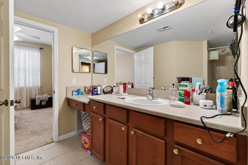 8550 Touchton Road, Unit 2221 Jacksonville, FL 32216 - Photo 30 of 53 a bathroom with a sink and a mirror