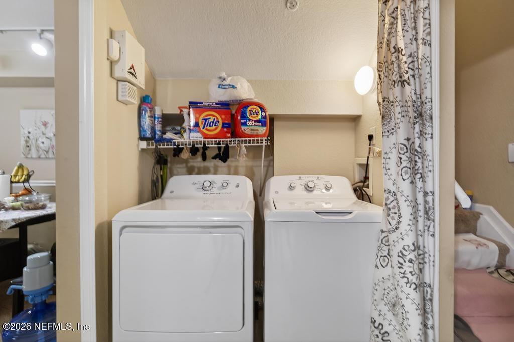 8550 Touchton Road, Unit 2221 Jacksonville, FL 32216 - Photo 32 of 53 a utility room with dryer and washer
