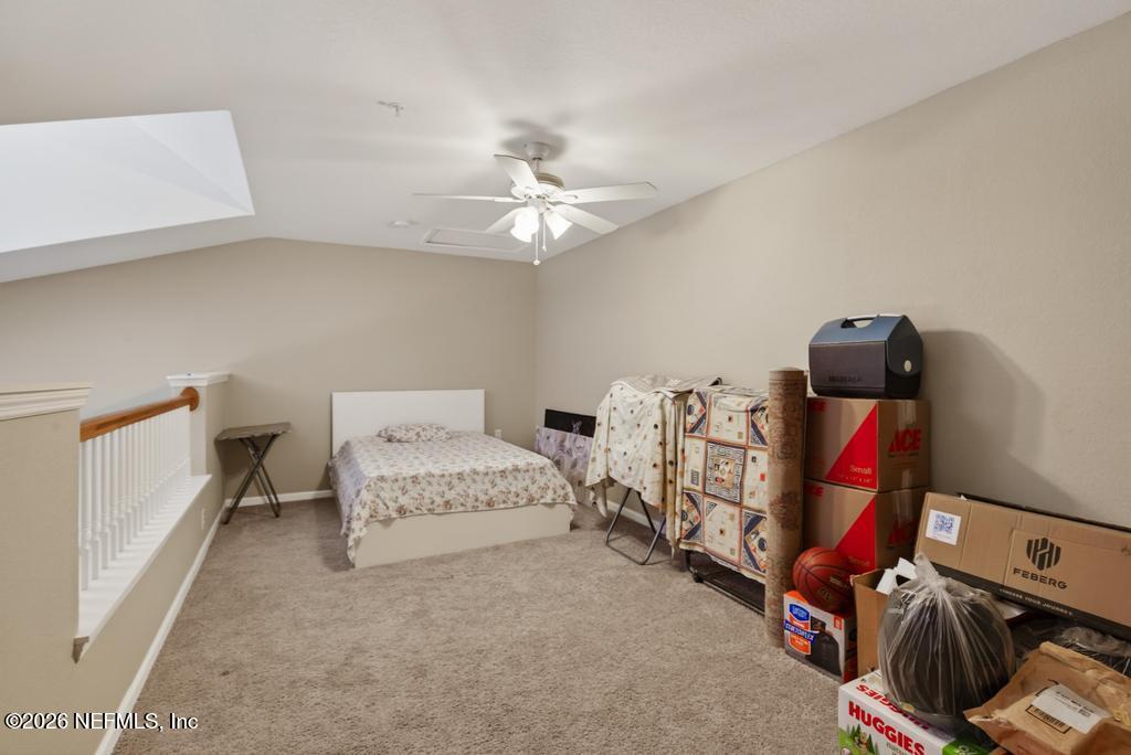 8550 Touchton Road, Unit 2221 Jacksonville, FL 32216 - Photo 34 of 53 a bedroom with furniture and a chandelier