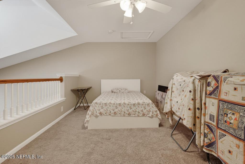 8550 Touchton Road, Unit 2221 Jacksonville, FL 32216 - Photo 35 of 53 a bedroom with a bed and a chandelier