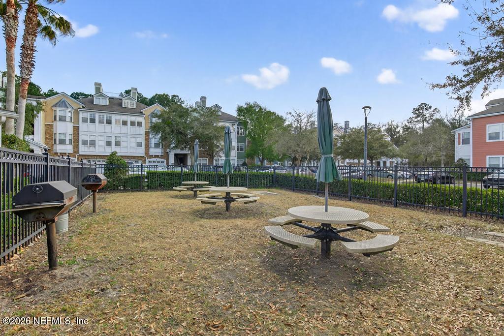 8550 Touchton Road, Unit 2221 Jacksonville, FL 32216 - Photo 50 of 53 a view of a backyard with sitting area and fire pit