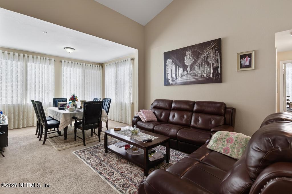 8550 Touchton Road, Unit 2221 Jacksonville, FL 32216 - Photo 5 of 53 a living room with furniture a large window and a table