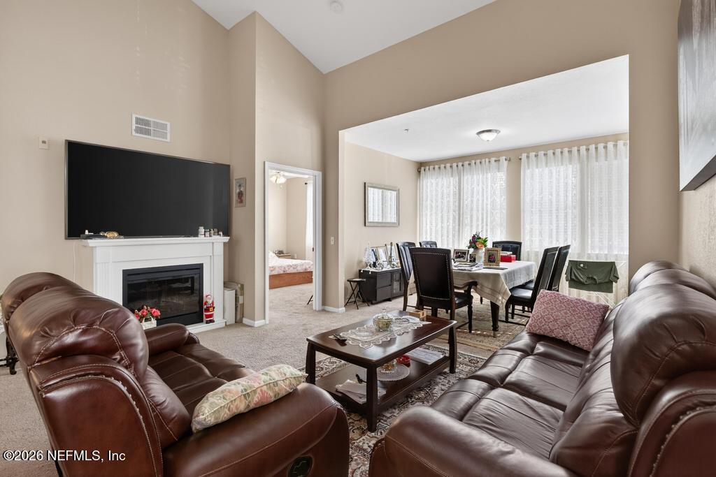 8550 Touchton Road, Unit 2221 Jacksonville, FL 32216 - Photo 6 of 53 a living room with furniture a fireplace and a flat screen tv