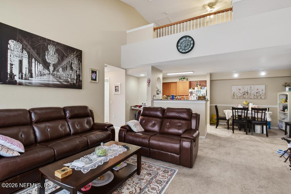8550 Touchton Road, Unit 2221 Jacksonville, FL 32216 - Photo 7 of 53 a living room with furniture and a mirror