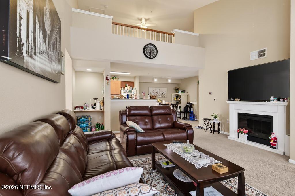8550 Touchton Road, Unit 2221 Jacksonville, FL 32216 - Photo 8 of 53 a living room with furniture a flat screen tv and a fireplace