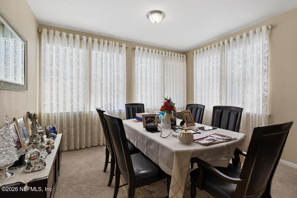 8550 Touchton Road, Unit 2221 Jacksonville, FL 32216 - Photo 10 of 53 a view of a dining room with furniture and window