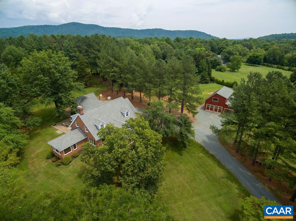 an aerial view of a house with a yard