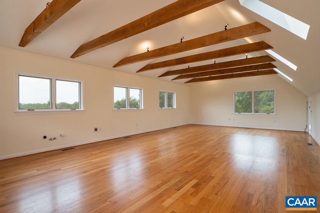 2903 Pea Ridge Road Charlottesville, VA 22901 - Photo 31 of 37 an empty room with wooden floor and windows