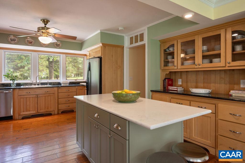 2903 Pea Ridge Road Charlottesville, VA 22901 - Photo 8 of 37 a kitchen with a sink and wooden cabinets