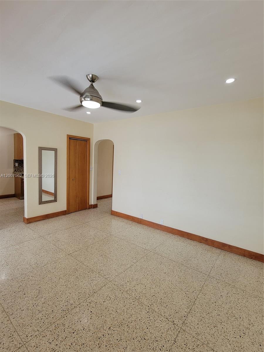 7400 Harding Avenue, Unit 15 Miami Beach, FL 33141 - Photo 12 of 26 a view of a livingroom with a ceiling fan and window
