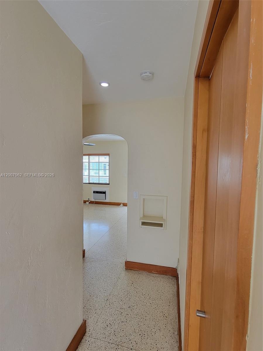 7400 Harding Avenue, Unit 15 Miami Beach, FL 33141 - Photo 15 of 26 a view of a hallway with wooden floor and a bathroom