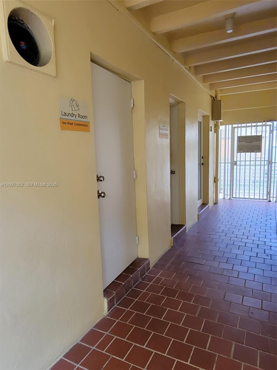 7400 Harding Avenue, Unit 15 Miami Beach, FL 33141 - Photo 23 of 26 a bedroom with a bed and a window