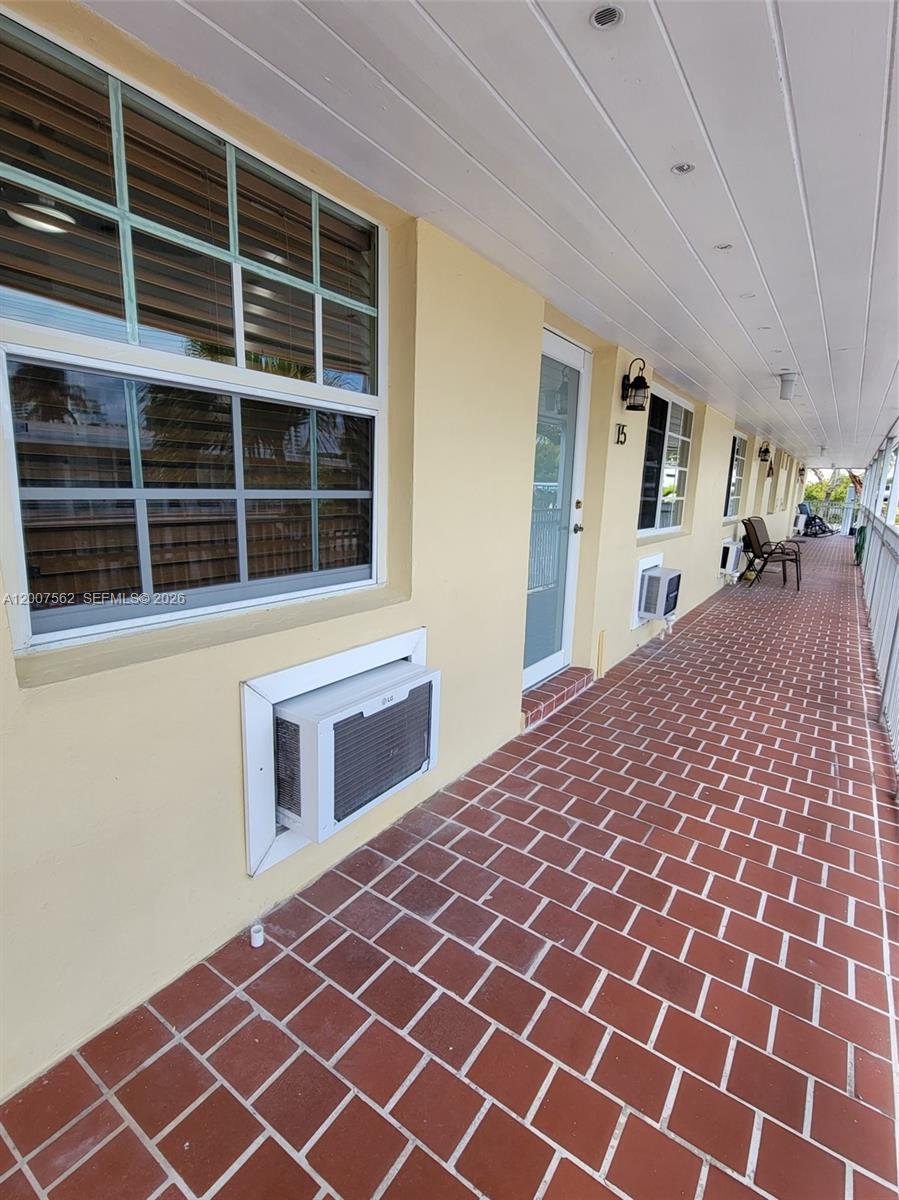 7400 Harding Avenue, Unit 15 Miami Beach, FL 33141 - Photo 8 of 26 a front view of a house with a yard