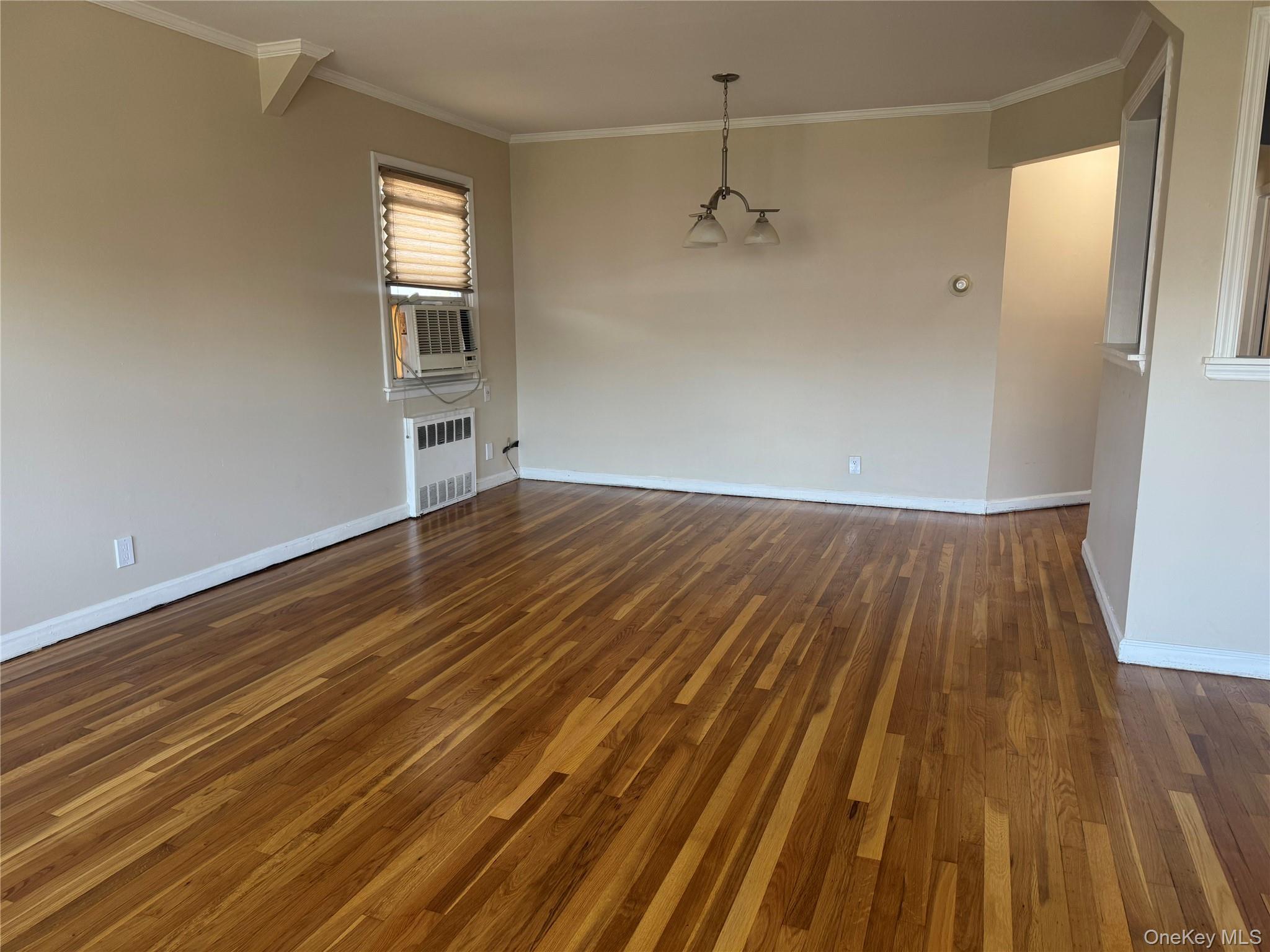 375 Cochran Place, Unit 2 Valley Stream, NY 11581 - Photo 6 of 12 an empty room with wooden floor and windows