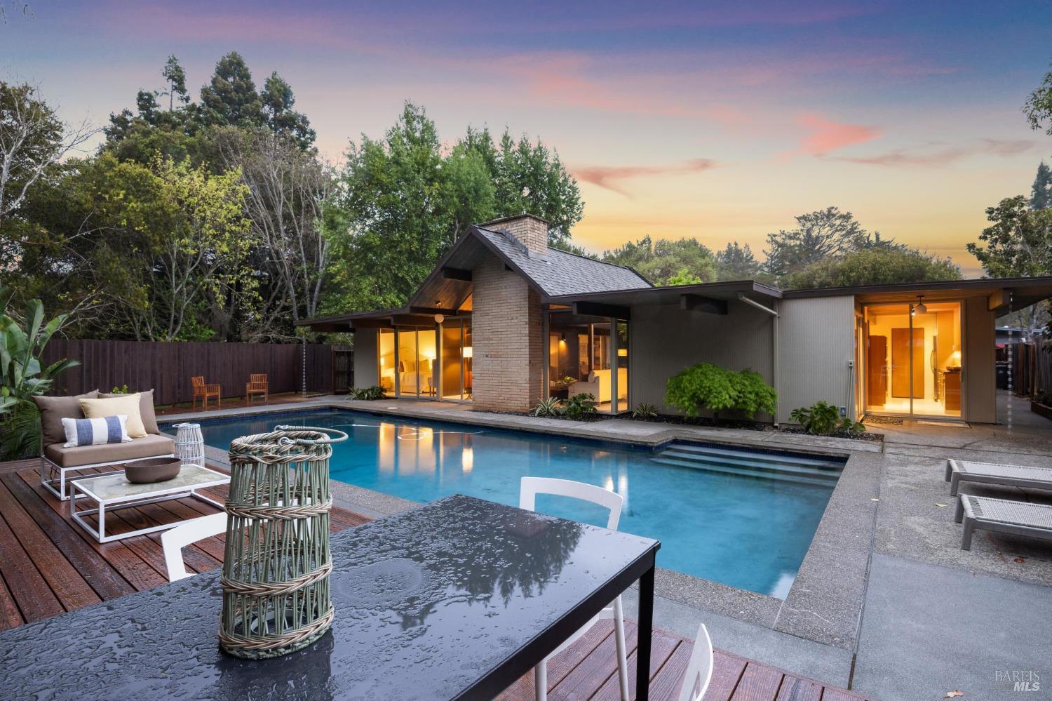 87 Mt Rainier Drive San Rafael, CA 94903 - Photo 1 of 1 a view of a house with pool fire pit couches and chairs