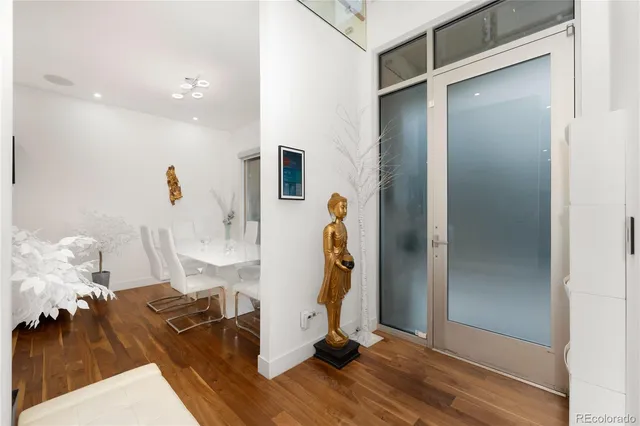 a kitchen with stainless steel appliances granite countertop a table chairs stove and refrigerator