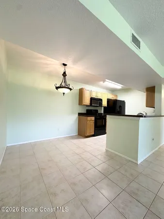 a view of a kitchen with microwave and cabinets