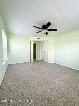 a view of an empty room and a window