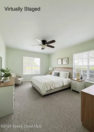 a spacious bedroom with a bed and a large window