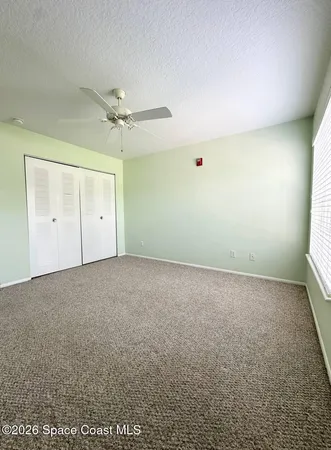 a bedroom with a bed couch and a window