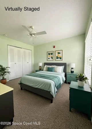 an empty room with a window and ceiling fan
