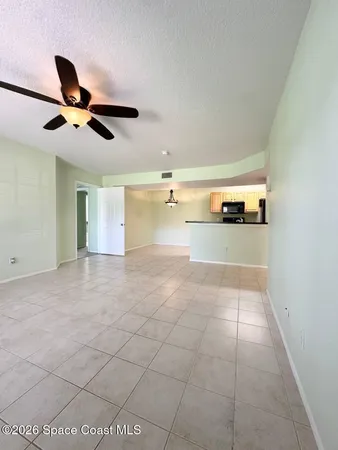 a view of a livingroom with a ceiling fan and window