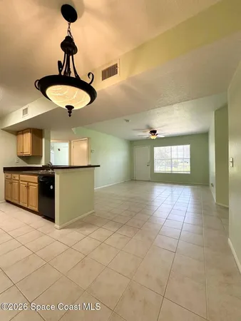 a view of a kitchen with a stove cabinets and a floor to ceiling window