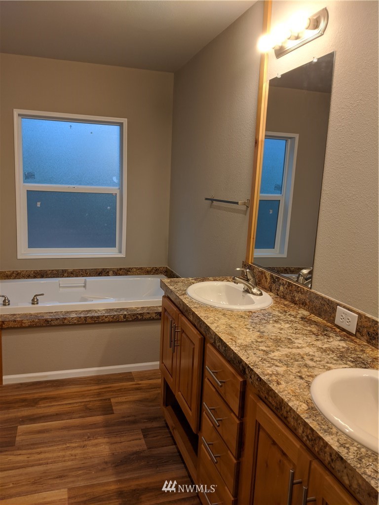 473 Harmon Road Chehalis, WA 98532 - Photo 13 of 15 a bathroom with a granite countertop sink and a mirror