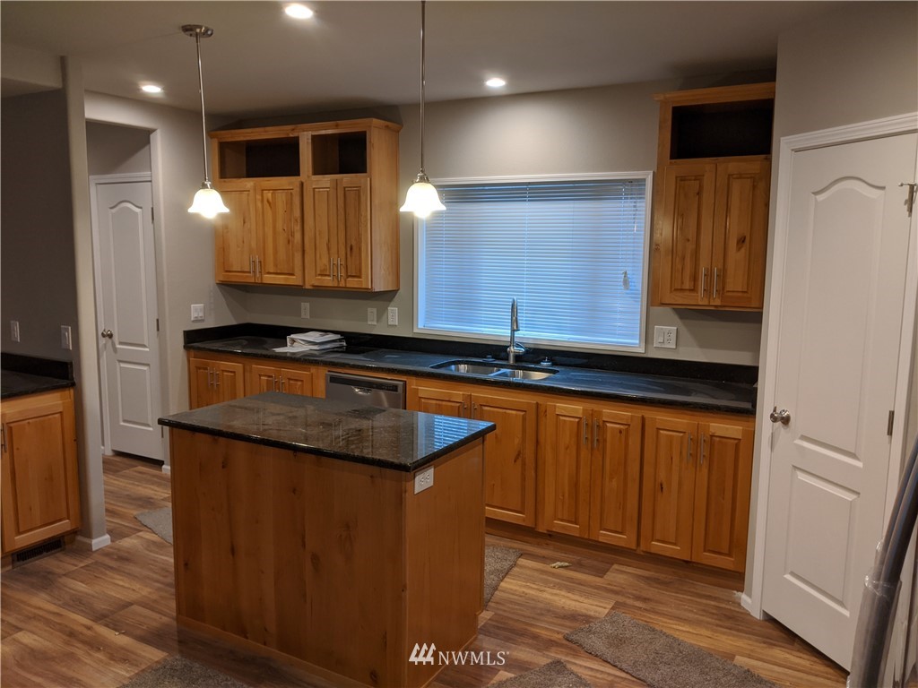 473 Harmon Road Chehalis, WA 98532 - Photo 6 of 15 a kitchen with granite countertop sink and cabinets