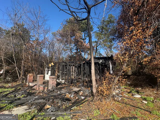 a backyard of a house with yard and outdoor seating