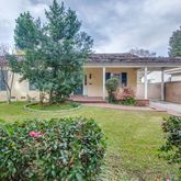 a view of a house with sitting area and garden