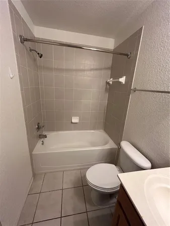 a bathroom with a toilet a sink and bathtub