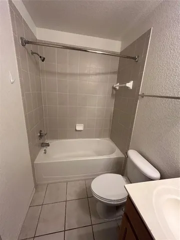 a bathroom with a toilet a sink and bathtub